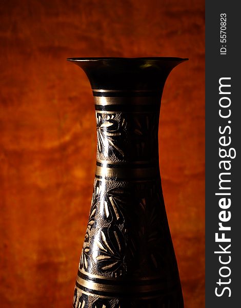 Vintage vase on wood background (focus on vase).