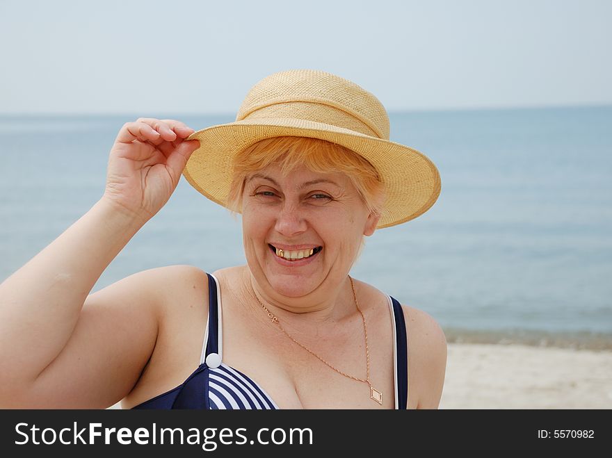 Woman in hat on sea background
