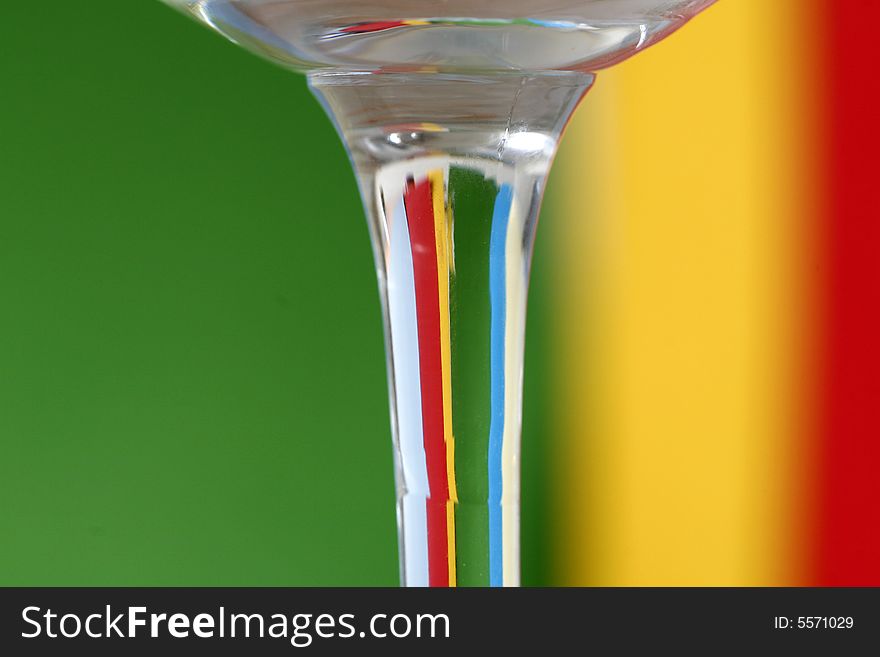 A glass with a simple green - yellow - red - blue color background. A glass with a simple green - yellow - red - blue color background