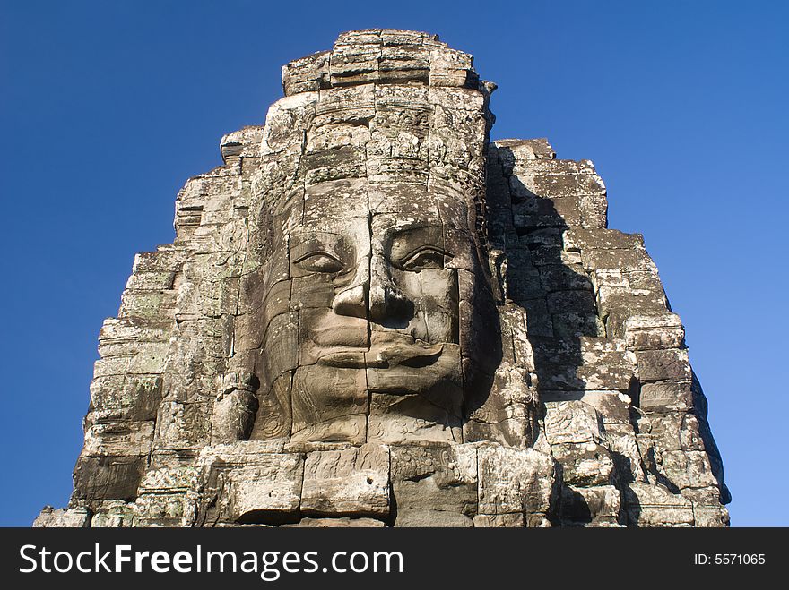 Huge buddha' faces in cambodia under very blue sky. Huge buddha' faces in cambodia under very blue sky