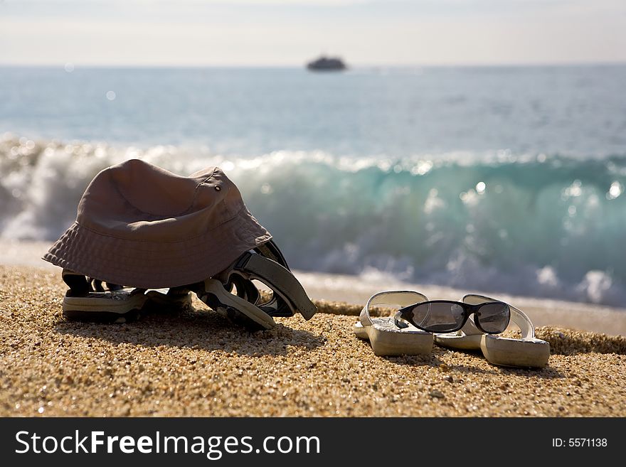 A photo of two pairs of beach shoes at the seaside