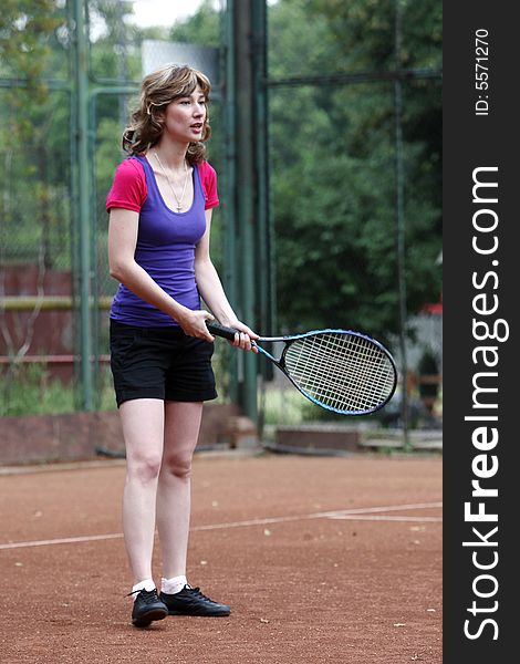 A tennis player girl in action