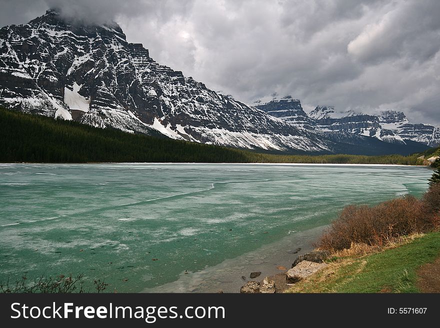 Frozen mountain lake under stormy clouds. Frozen mountain lake under stormy clouds.