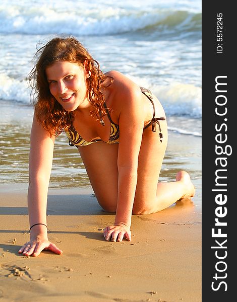 Young beautiful woman at the beach enjoying the sun. Ideal summer / vacation shot. Young beautiful woman at the beach enjoying the sun. Ideal summer / vacation shot.