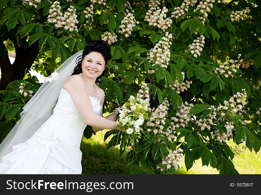 A happy bride near the tree. A happy bride near the tree