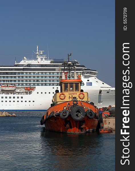 A big modern and small old ship in port. A big modern and small old ship in port