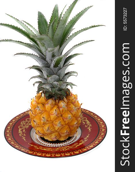 Very delicious and appetizing pineapple in a beautiful saucer on a white background