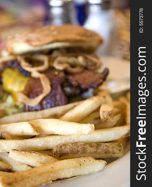 A bacon cheeseburger and order of french fries. A bacon cheeseburger and order of french fries