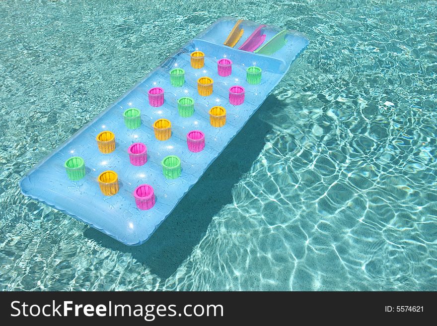 Colorful raft floating in swimming pool, horizontal