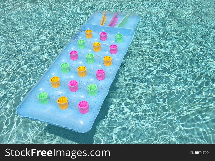 Colorful pool toy floating in water. Colorful pool toy floating in water