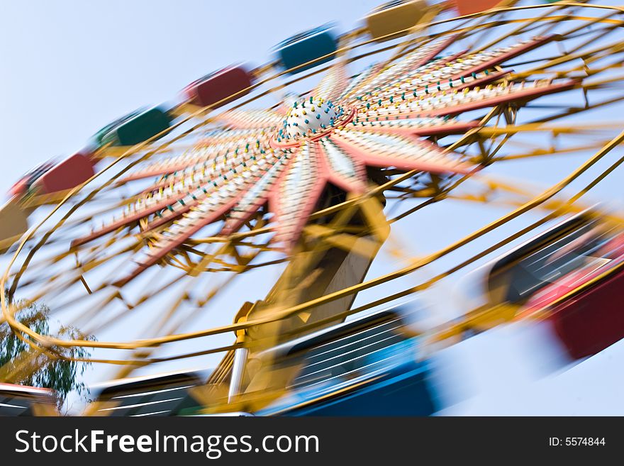 colorful ferris wheel in amusement park, motion blur, beijing, china.