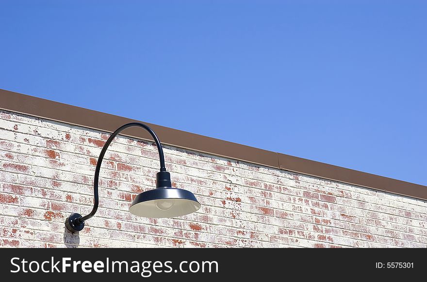 An old fashioned street light on an old brick wall. An old fashioned street light on an old brick wall