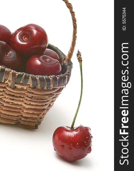 Cherry in a basket on white.