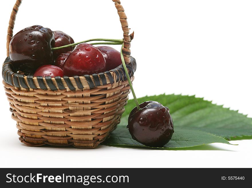 Cherry in a basket on white.