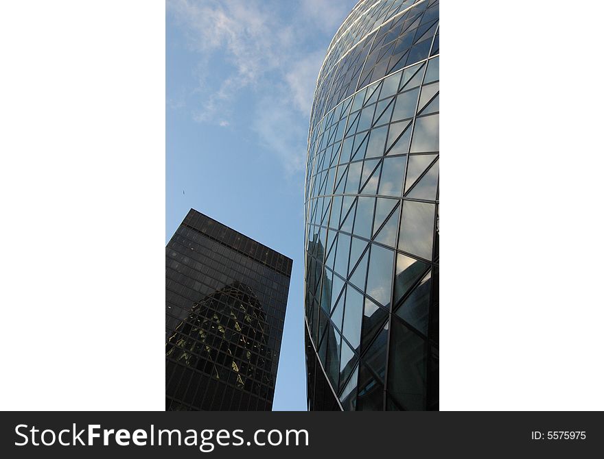 Looking up at a skyscraper popularly known as 'The Gherkin' in London. Looking up at a skyscraper popularly known as 'The Gherkin' in London.