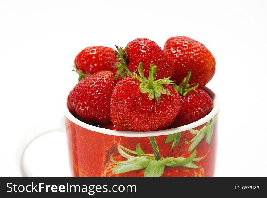 Ripe strawberry in the cup isolated on white background