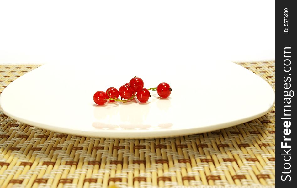 Red currant on a white plate