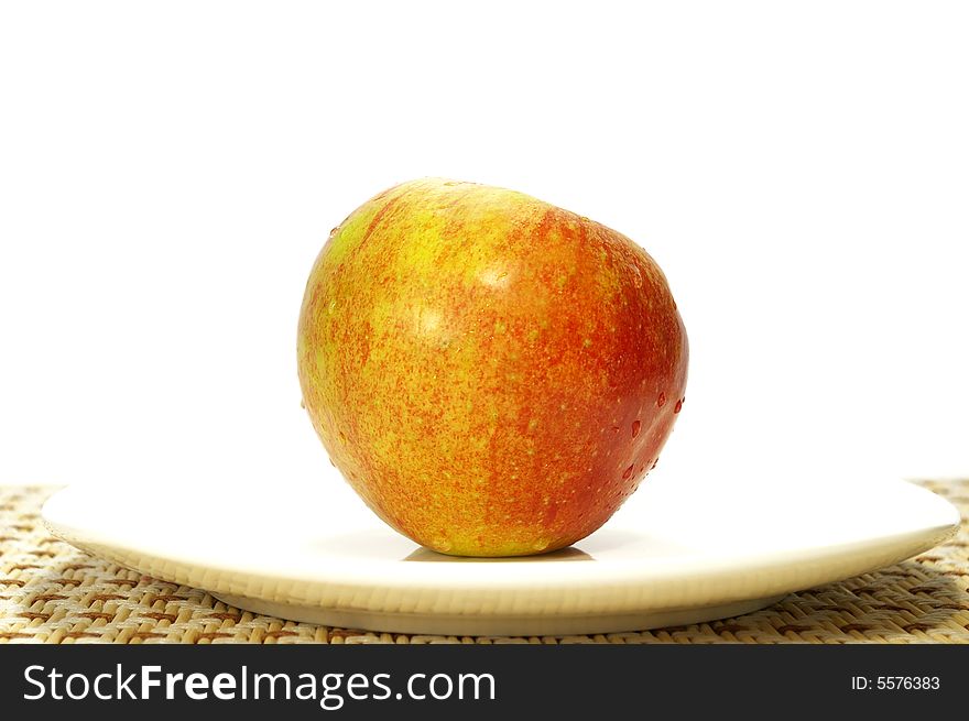 Ripe juicy apple on a white plate. Ripe juicy apple on a white plate