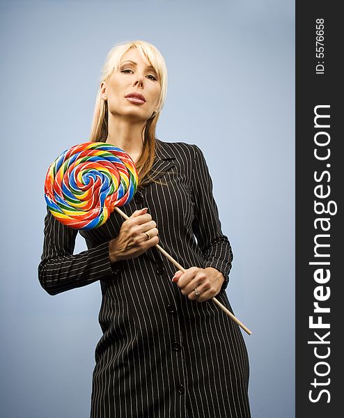 Woman holding a big colorful lollipop. Woman holding a big colorful lollipop