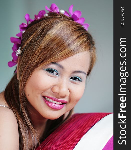 Portrait of a beautiful Asian bride with flowers in her hair.