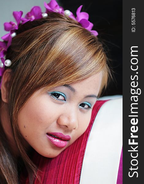 Portrait of a beautiful Asian bride with flowers in her hair.