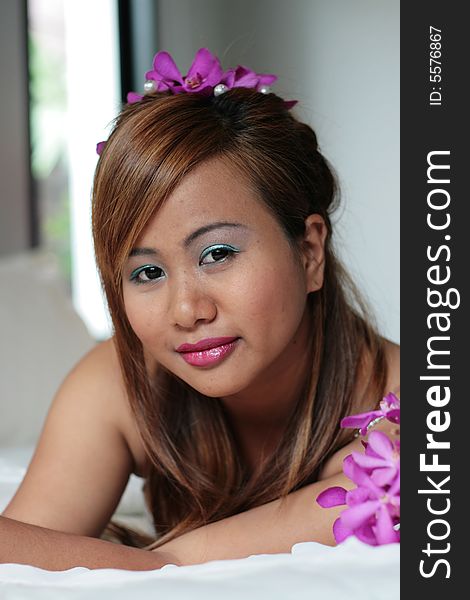 Portrait of a beautiful Asian bride with flowers in her hair.