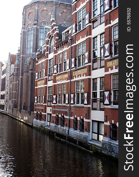 Picture of canal and historic industrial building in Amsterdam, The Netherlands. Picture of canal and historic industrial building in Amsterdam, The Netherlands.