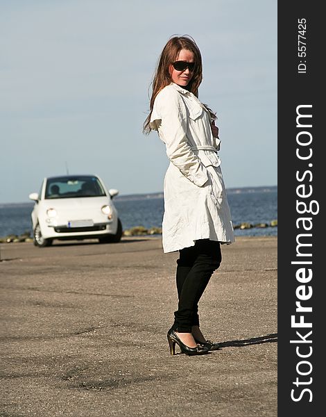 Young lady posing near a car