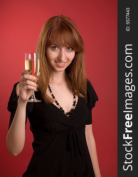 Beautiful girl with champagne glass isolated on red background