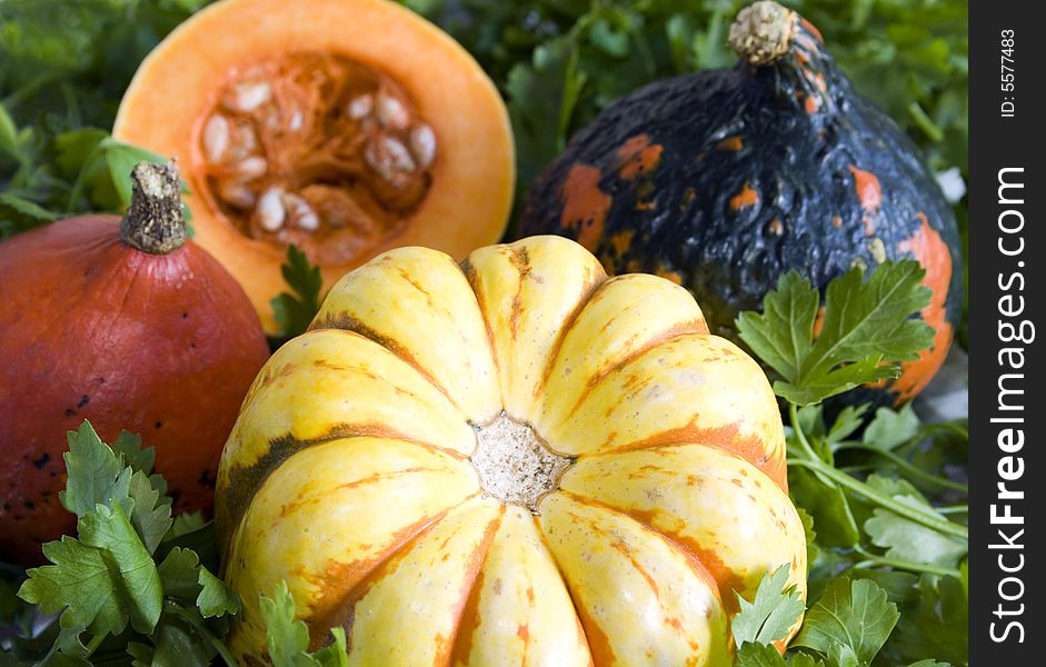 Close up of different types of pumpkin: ambercup, carnival squash and butternut. Focus on the pumpkin at the front. Close up of different types of pumpkin: ambercup, carnival squash and butternut. Focus on the pumpkin at the front.