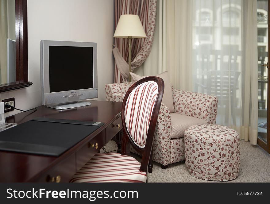 Interior of a modern hotel room with furniture.