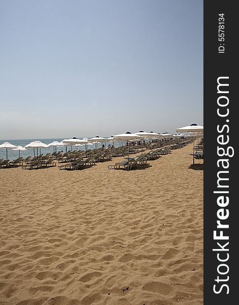 Beach view with chairs and umbrellas. Beach view with chairs and umbrellas