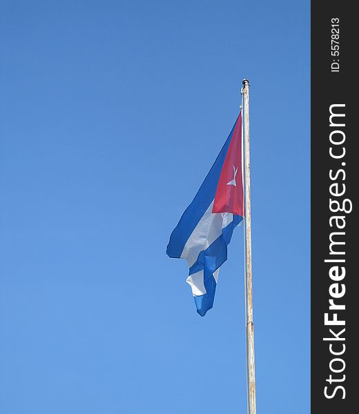 Cuban flag against blue sky