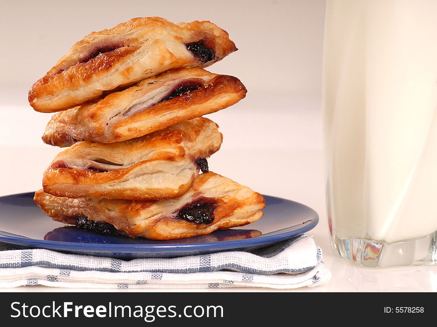 Freshly baked blueberry turnovers with a glass of milk. Freshly baked blueberry turnovers with a glass of milk