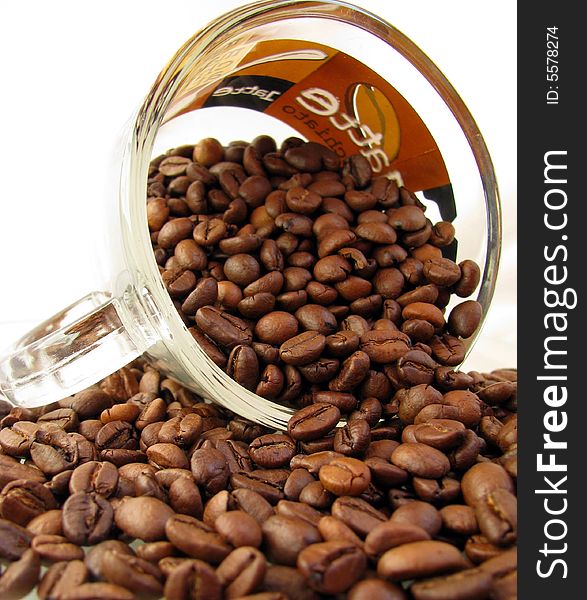 Coffee beans and cup of coffe on white background