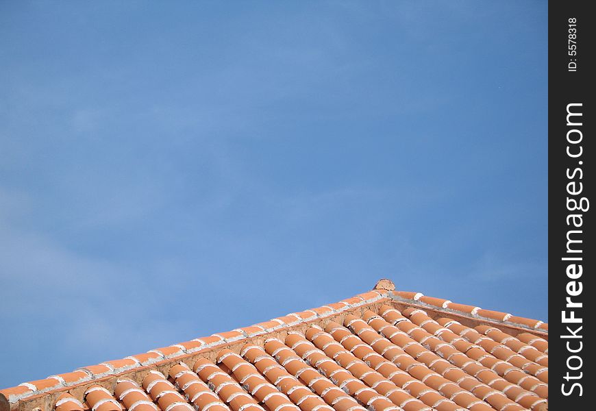 Orange clay roof against blue sky