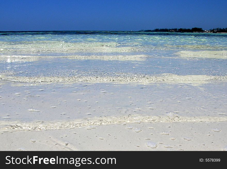 Little waves of crystal water on Grand Bahama Island beach, The Bahamas. Little waves of crystal water on Grand Bahama Island beach, The Bahamas.