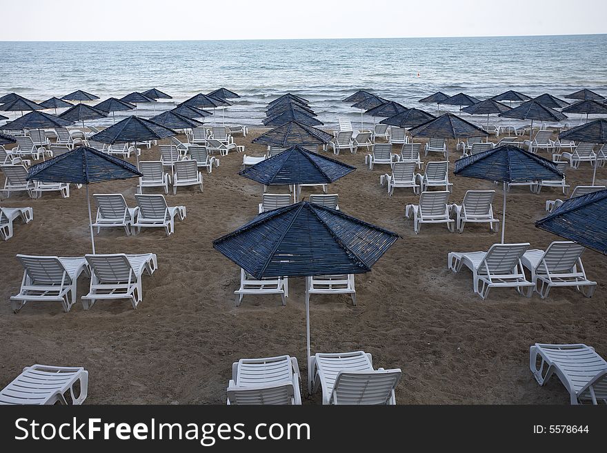 Beach view with chairs and umbrellas. Beach view with chairs and umbrellas