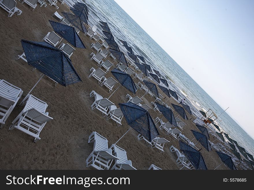 Beach view with chairs and umbrellas. Beach view with chairs and umbrellas