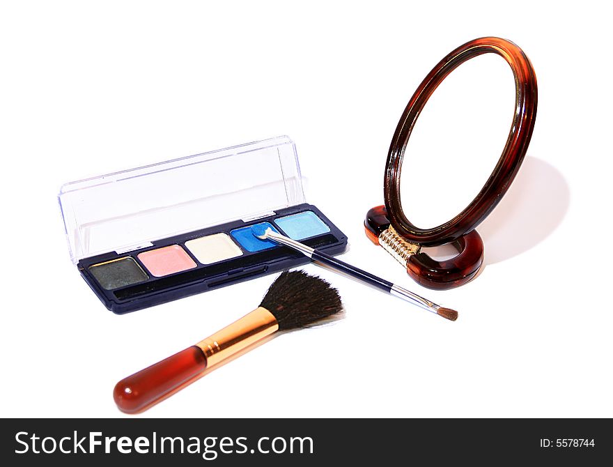 Cosmetic set - shadows for eyes, a mirror and a brush