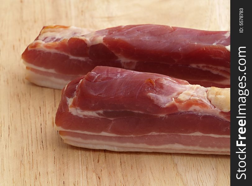 Smoked bacon on wooden cutting board. Smoked bacon on wooden cutting board