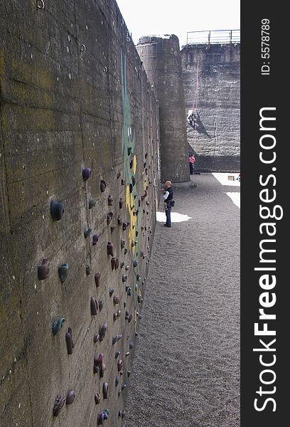 People practicing rock climbing at an old industrial building