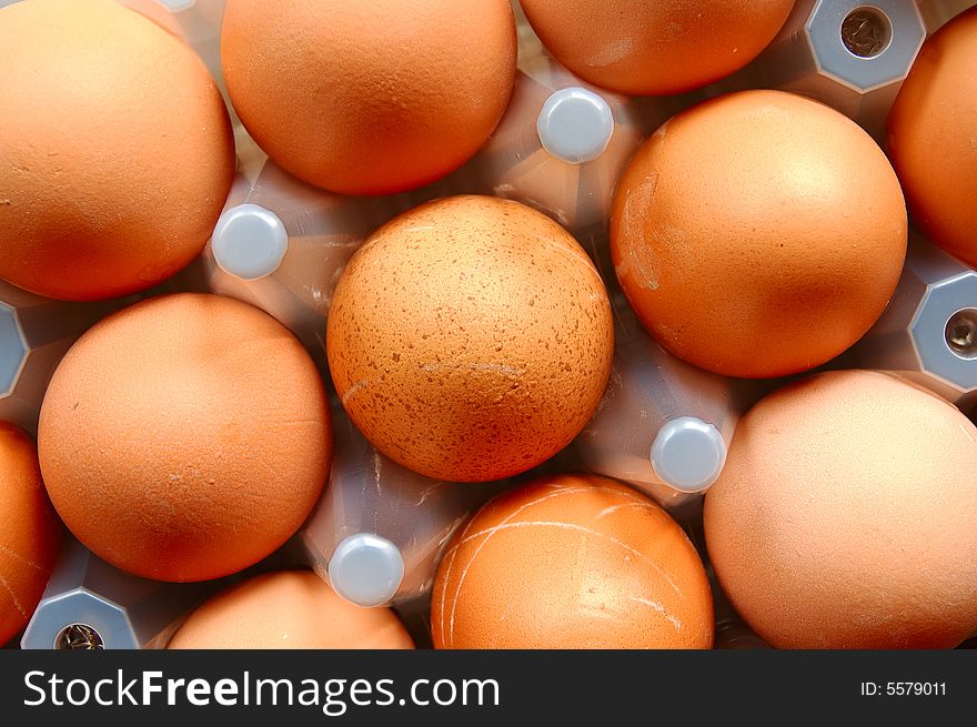 A set of brown eggs in a plastic tray. A set of brown eggs in a plastic tray