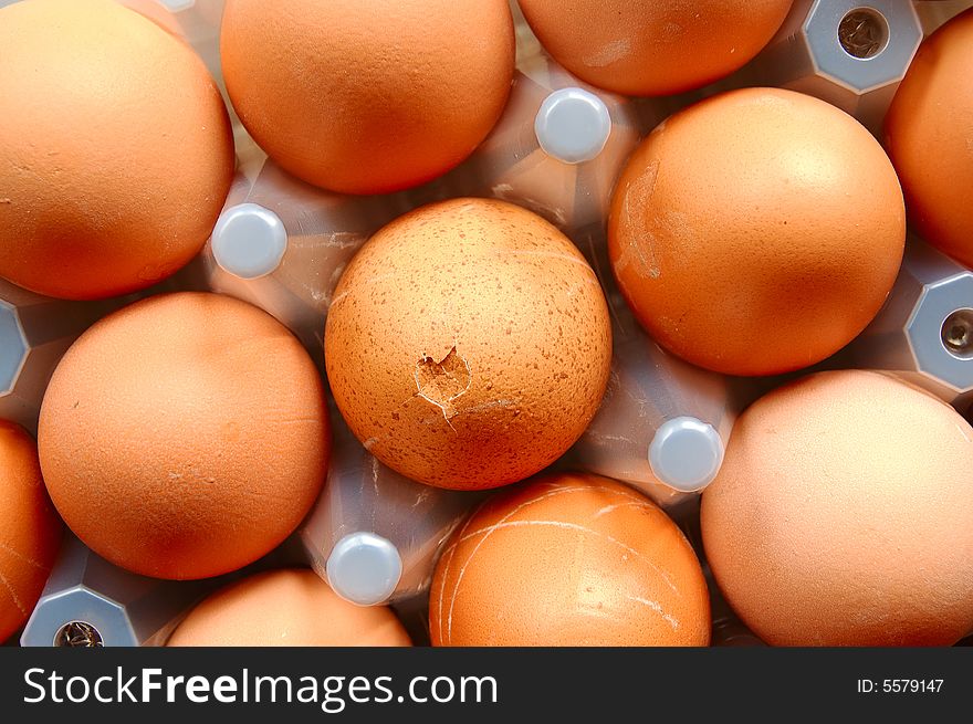 A set of brown eggs in a plastic tray. A set of brown eggs in a plastic tray