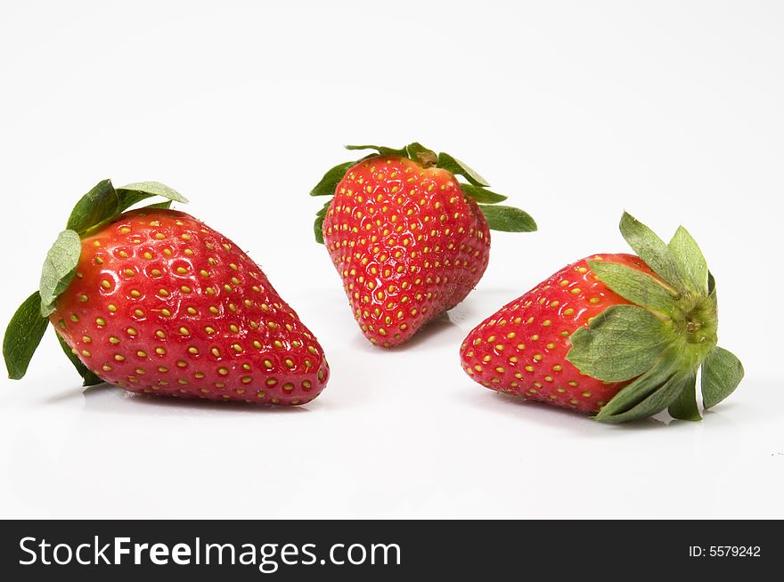 Closeup of three large juicy red strawberries on white background. Closeup of three large juicy red strawberries on white background