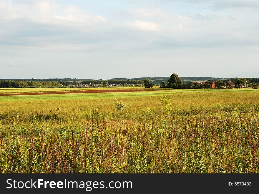 The countryside field filled with sunset light in Lithuania. The countryside field filled with sunset light in Lithuania.