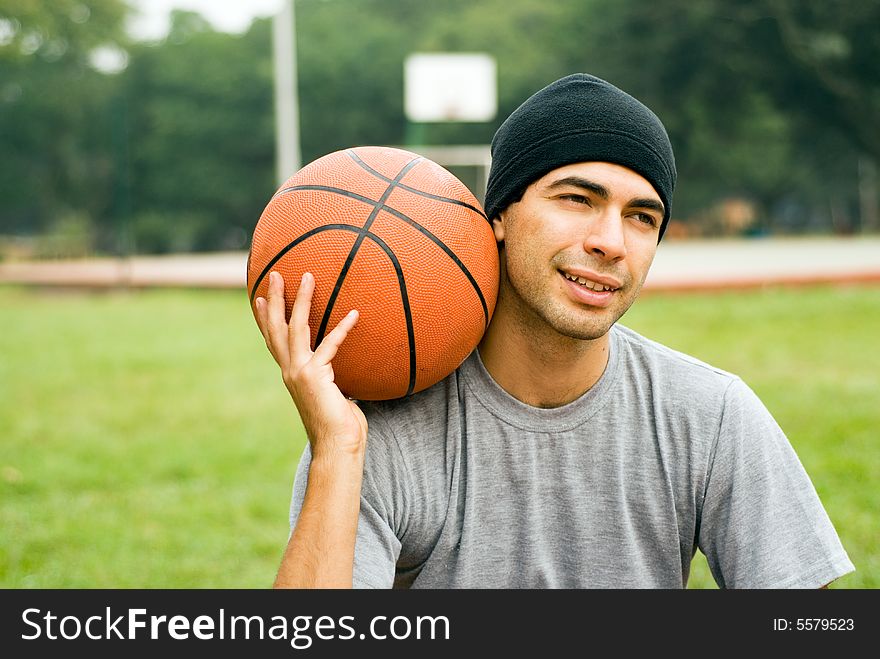 Man in Park Holding Basketball - Horizontal