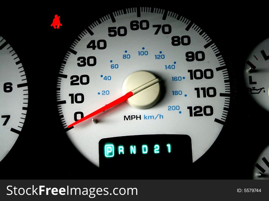 Crisp image of a speedometer with white face