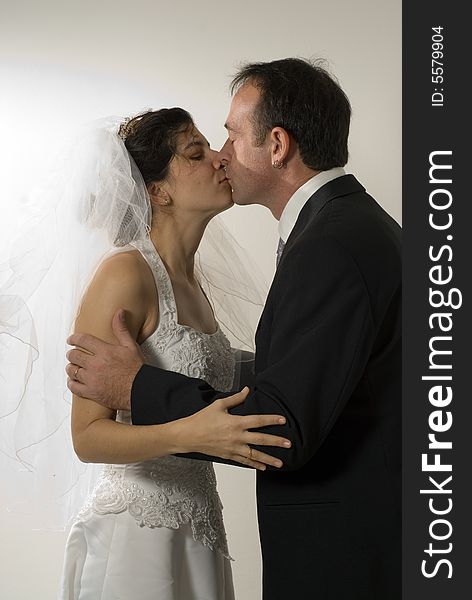 Newlyweds Kissing - vertical