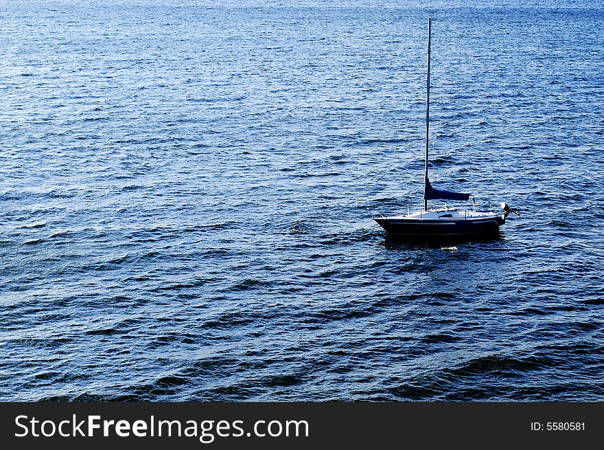 Sailboat out in the blue water. Sailboat out in the blue water